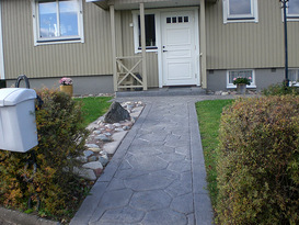 Entrée/uppfart i markbetong med stenar och gräs